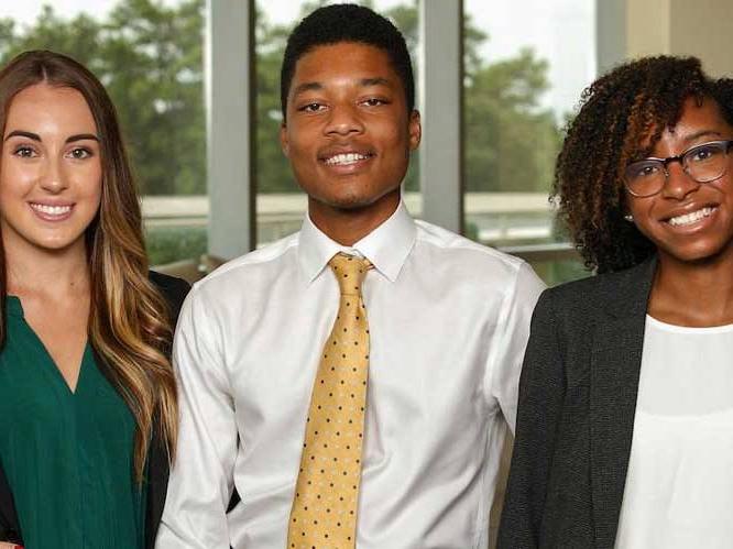 Group of business students smiling for a picture