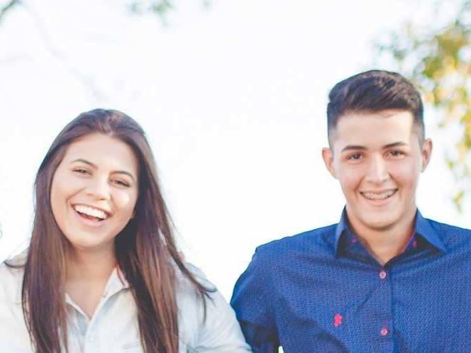 Man and woman standing together smiling for a picture