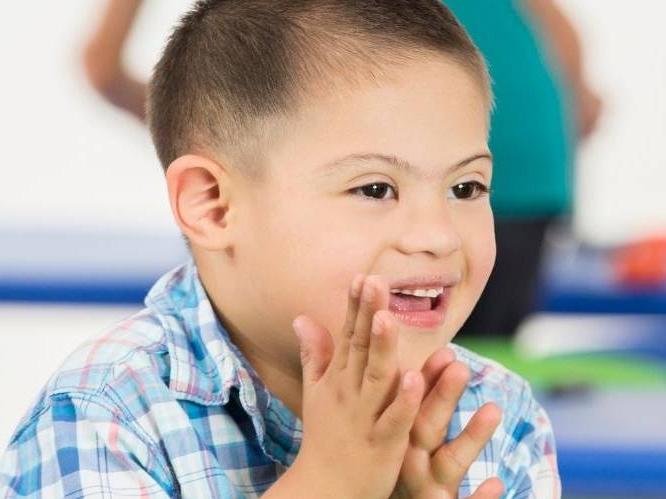 Young child clapping his hands