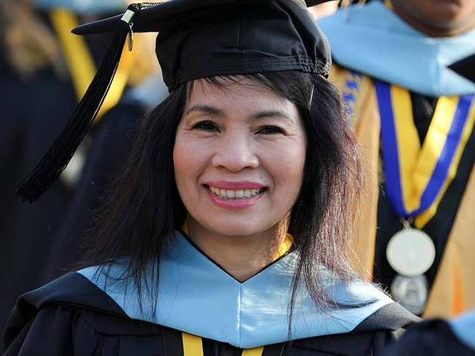 Student graduating smiling